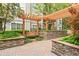 Relax in the courtyard with a swing under a pergola and stone planters at 1502 River Green Nw Dr # 1502, Atlanta, GA 30327