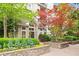 A welcoming building entrance with vibrant flowers and lush landscaping at 1502 River Green Nw Dr # 1502, Atlanta, GA 30327