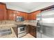 Updated kitchen with stainless steel appliances and granite countertops with wooden cabinets at 1502 River Green Nw Dr # 1502, Atlanta, GA 30327