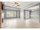 Spacious living room with fireplace, ceiling fan, and shuttered windows at 1502 River Green Nw Dr # 1502, Atlanta, GA 30327