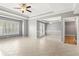 Spacious living room with tiled floors, ceiling fan, large windows with plantation shutters and double glass patio doors at 1502 River Green Nw Dr # 1502, Atlanta, GA 30327