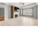 Spacious living room featuring a stone fireplace, trey ceilings, and tiled flooring at 1502 River Green Nw Dr # 1502, Atlanta, GA 30327