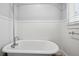 Vintage bathroom features a standalone tub with elegant chrome fixtures, complemented by beadboard paneling at 203 Lucerne St, Decatur, GA 30030