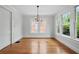 Dining room with hardwood floors, neutral paint, and a vintage chandelier creating a versatile space at 203 Lucerne St, Decatur, GA 30030