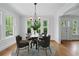 Dining room with hardwood floors, natural light, and a round table set for a meal at 203 Lucerne St, Decatur, GA 30030