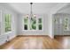 Bright dining room with hardwood floors, natural light, and elegant chandelier at 203 Lucerne St, Decatur, GA 30030