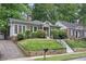 Charming brick home with beautiful landscaping, well-manicured lawn and inviting walkway at 203 Lucerne St, Decatur, GA 30030