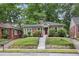 Charming brick bungalow with lush front lawn and inviting red door entrance at 203 Lucerne St, Decatur, GA 30030