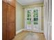 Bright hallway with wooden cabinets leads to double glass doors and view of the backyard at 203 Lucerne St, Decatur, GA 30030