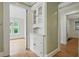 Hallway featuring built-in shelving, hardwood floors, and an open doorway at 203 Lucerne St, Decatur, GA 30030