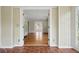 Hallway with hardwood floors, white trim, and a view into another room creating a sense of flow at 203 Lucerne St, Decatur, GA 30030
