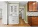 Hallway featuring built-in shelving, hardwood floors, and views into the kitchen at 203 Lucerne St, Decatur, GA 30030