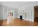 Spacious living room with hardwood floors, fireplace, built-ins, and French doors leading to sunroom at 203 Lucerne St, Decatur, GA 30030