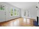 Bright living room featuring hardwood floors, fireplace, and multiple windows offering scenic views at 203 Lucerne St, Decatur, GA 30030