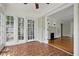 Bright sunroom featuring terracotta tile flooring, multiple windows, and French doors to living room at 203 Lucerne St, Decatur, GA 30030