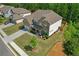 Aerial view of a brick house with manicured lawn, mature trees, and a paved driveway in a suburban setting at 319 Parkside Meadow Dr, Marietta, GA 30064