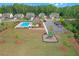 Aerial view of community amenities: pool, park and playground amidst well-maintained homes and green spaces at 319 Parkside Meadow Dr, Marietta, GA 30064