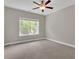 Neutral bedroom featuring a ceiling fan, large window, and carpet flooring at 319 Parkside Meadow Dr, Marietta, GA 30064