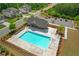 Aerial view of a sparkling community pool with a covered seating area and ample parking nearby at 319 Parkside Meadow Dr, Marietta, GA 30064