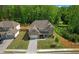 Beautiful two-story home with brick and siding, manicured lawn, and a long driveway leading to a two-car garage at 319 Parkside Meadow Dr, Marietta, GA 30064