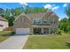 Charming two-story brick and siding home with a well-manicured lawn and a spacious driveway at 319 Parkside Meadow Dr, Marietta, GA 30064