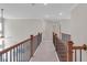 Hallway with railing and neutral colors, offering a view of doors and fixtures at 319 Parkside Meadow Dr, Marietta, GA 30064