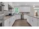 Modern kitchen featuring white cabinets, granite countertops, stainless steel appliances, and a central island at 319 Parkside Meadow Dr, Marietta, GA 30064