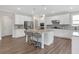 Contemporary kitchen with white cabinets, a center island with seating, granite countertops, and stainless steel appliances at 319 Parkside Meadow Dr, Marietta, GA 30064