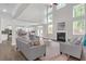 Open-concept living room featuring soaring ceilings, fireplace and view to a modern kitchen with stainless appliances at 319 Parkside Meadow Dr, Marietta, GA 30064