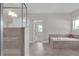Bright main bathroom with tiled floors, walk-in shower and soaking tub at 319 Parkside Meadow Dr, Marietta, GA 30064