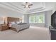 Main bedroom features a bed, side tables, ceiling fan, and a tray ceiling at 319 Parkside Meadow Dr, Marietta, GA 30064