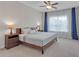 Main bedroom with wooden bed frame, side tables, lamps, and an airy window with curtains at 319 Parkside Meadow Dr, Marietta, GA 30064