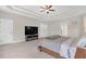 Main bedroom featuring a large TV, ceiling fan and access to the main bathroom at 319 Parkside Meadow Dr, Marietta, GA 30064