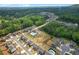 Expansive aerial shot showcasing a residential neighborhood nestled amongst lush green trees and scenic landscapes at 319 Parkside Meadow Dr, Marietta, GA 30064