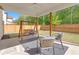 Inviting covered patio with swing and seating, overlooking a fenced backyard with lush greenery at 319 Parkside Meadow Dr, Marietta, GA 30064