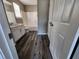 Bathroom features wood-look floors, a tub, vanity, and abundant storage behind white doors at 4510 Swan Trce, Atlanta, GA 30349