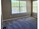 Neutral bedroom offers natural light through large windows and features plush gray carpeting at 4510 Swan Trce, Atlanta, GA 30349