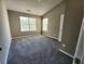 Bright bedroom with vaulted ceiling features plush gray carpeting and large, light-filled windows at 4510 Swan Trce, Atlanta, GA 30349
