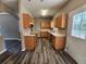 Bright kitchen featuring light wood cabinets, neutral countertops, and modern flooring near door at 4510 Swan Trce, Atlanta, GA 30349