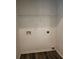 This laundry room features connections for a washer and dryer and built-in shelving at 4510 Swan Trce, Atlanta, GA 30349