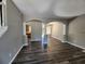 Open-concept living room featuring dark wood floors, columns, arched doorways and fresh paint at 4510 Swan Trce, Atlanta, GA 30349