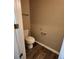 Cozy powder room features a toilet, towel bar, and wood-look flooring at 4510 Swan Trce, Atlanta, GA 30349