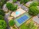 Aerial view showcases the community pool, tennis court, and surrounding landscaped grounds at 605 Parkaire Xing, Marietta, GA 30068