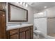 Updated bathroom featuring a granite countertop, wood cabinets, and a tiled stand up shower at 605 Parkaire Xing, Marietta, GA 30068