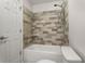 Bathroom features a tile accent wall, new toilet, and shower/tub combo at 605 Parkaire Xing, Marietta, GA 30068