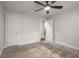 Spacious bedroom with carpet and fan, with multiple entry doors for easy access at 605 Parkaire Xing, Marietta, GA 30068