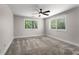 Spacious bedroom with a ceiling fan, neutral paint, plush carpet, and large windows at 605 Parkaire Xing, Marietta, GA 30068