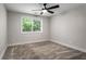 Carpeted bedroom with modern ceiling fan and window providing natural light at 605 Parkaire Xing, Marietta, GA 30068