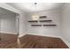 Open dining room featuring floating shelves, hardwood floors, and stylish pendant lighting at 605 Parkaire Xing, Marietta, GA 30068
