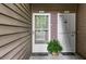 Dual entrance to units with a cozy welcome mat and fresh plant, exemplifying the inviting atmosphere at 605 Parkaire Xing, Marietta, GA 30068